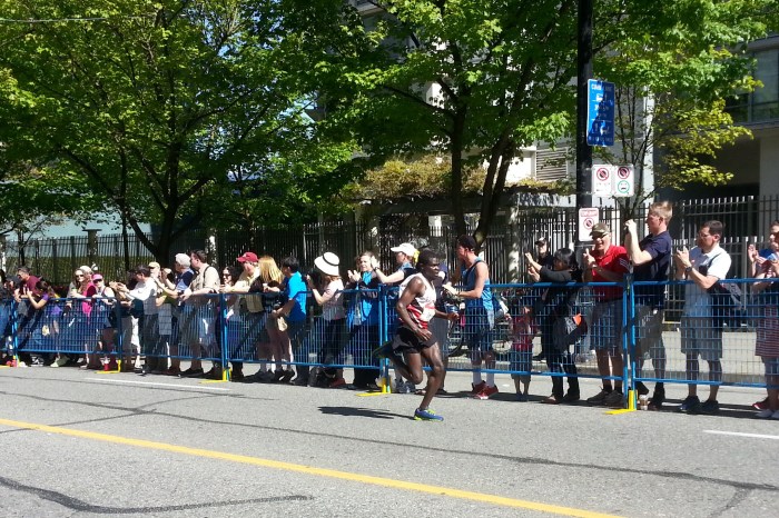 The full marathon winner laps most of the half-marathoners, having started an hour later.